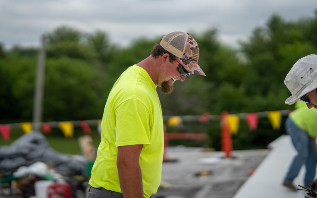 HCI crew portrait — flat roof work, crew shot, hi vis safety gear