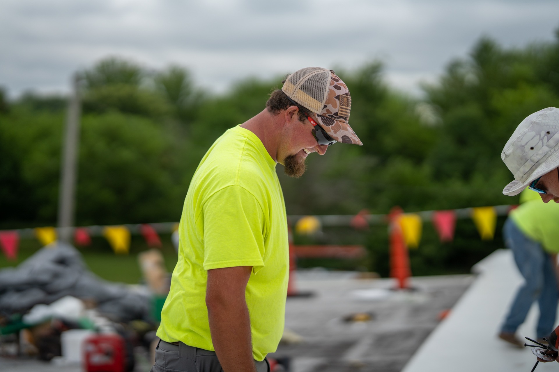 HCI crew portrait — flat roof work, crew shot, hi vis safety gear